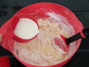 Mix the dry ingredients with a spatula. Add milk and beat in the beater on a low medium speed.