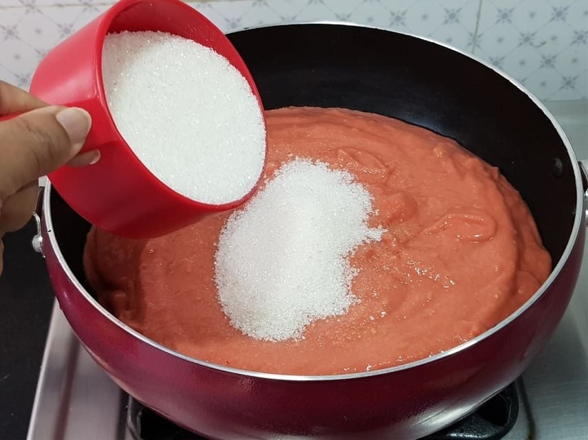 In a pan add guava puree and sugar.
