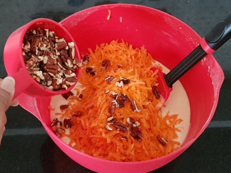 adding freshly grated carrot and toasted pecans broken into pieces