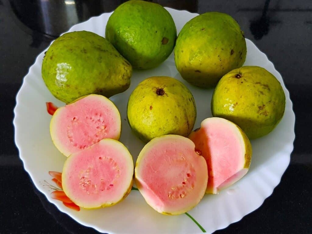 pink guavas are washed and cut in halves