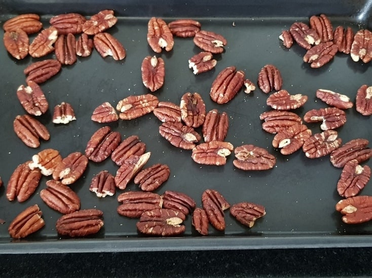 toasted pecans on a baking tray
