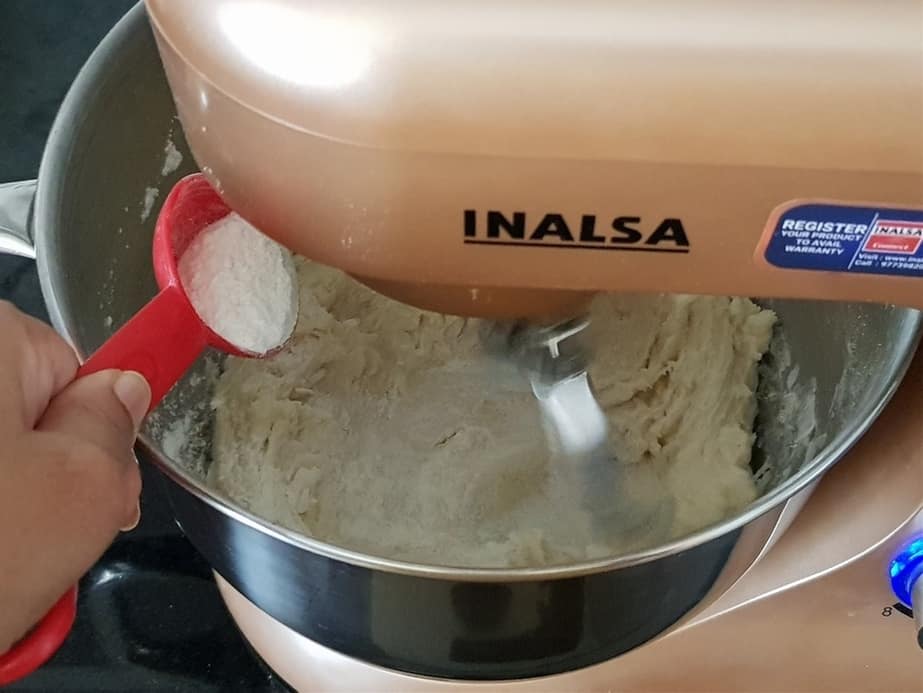 Turn on the machine to knead the dough. add a teaspoon of reserved flour little at a time.