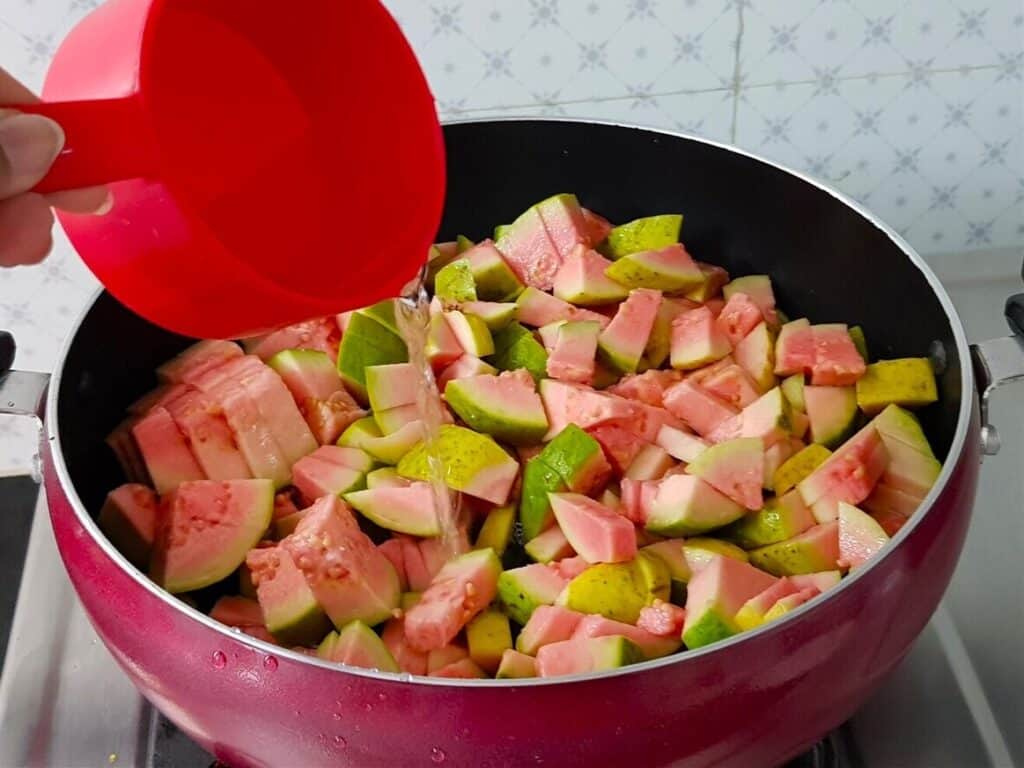 In a pan add guavas with a cup of water and cook until soft.