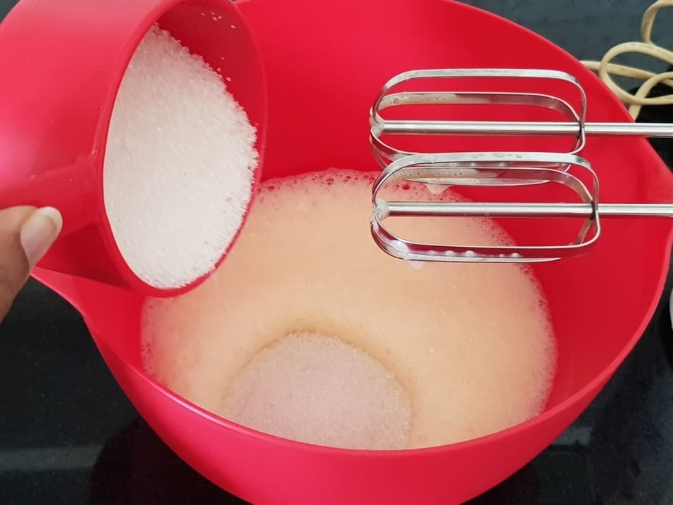 beat eggs in an electric beater until frothy. Add sugar to it.