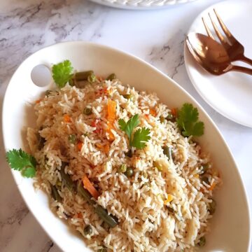 vegetable pulao in a white serving platter