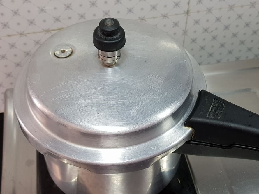 cover the pressure cooker lid and cook for two whistles and sim for two minutes
