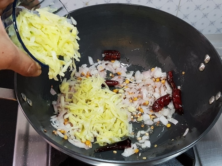 add grated raw mango and saute for a few seconds