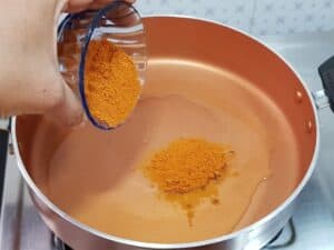 add oil in a frying pan on a medium heat.to it add chilli or sambhar powder for egg masala fry