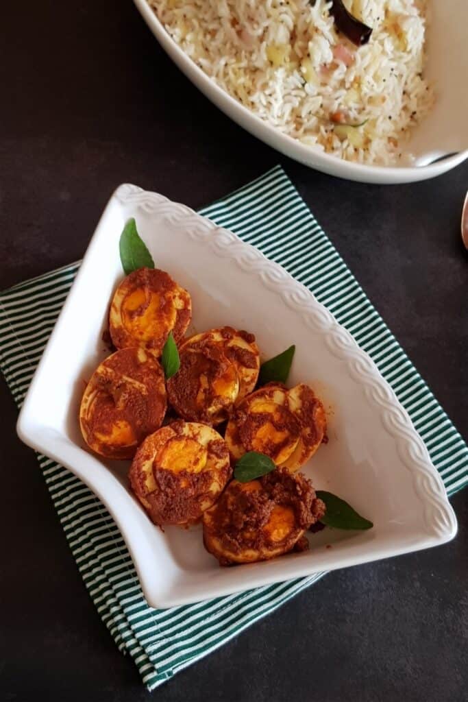 transfer the egg masala fry to a serving dish