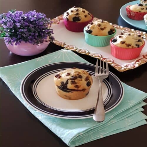 Blueberry chocolate chip muffins on a plate.