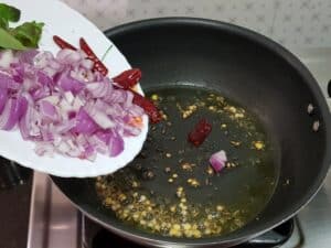 add chopped onions, dried chillies and curry leaves