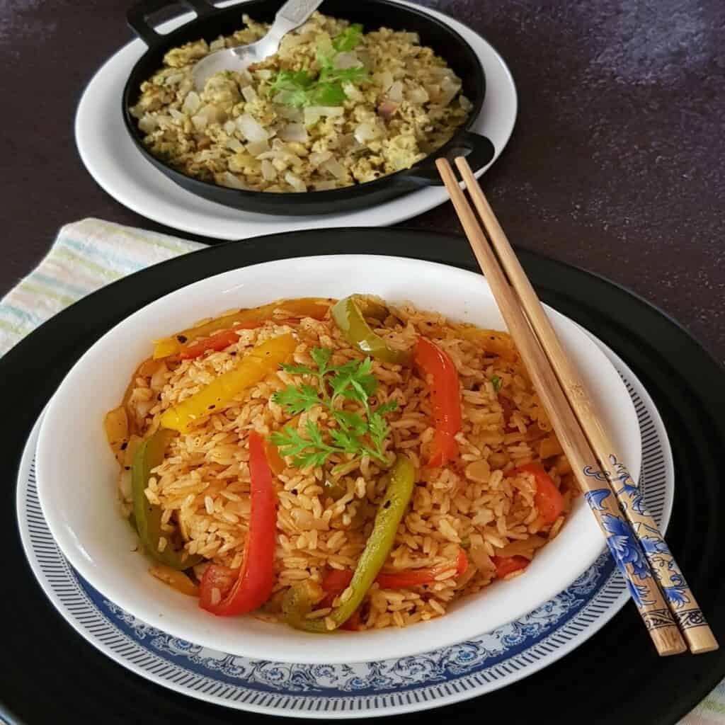 schezwan fried rice served on bowl with chopsticks