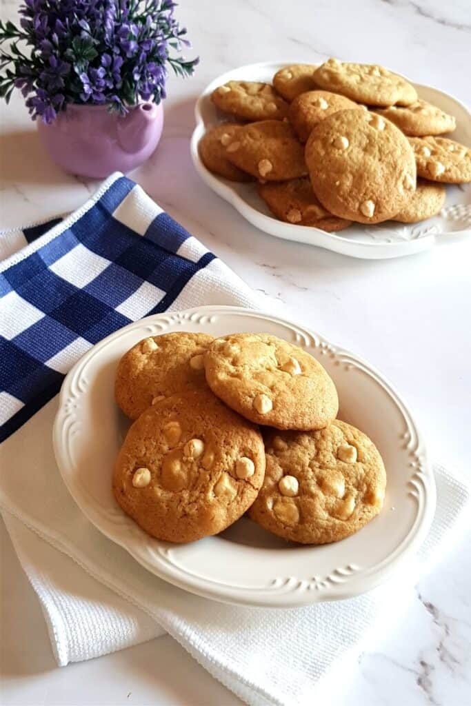 soft chewy white chocolate cookies on a white serving plate