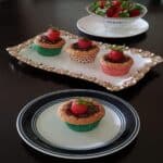 Strawberry cupcake with strawberry filling served on a serving plate.