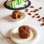 Egg-free banana muffins with pecans on a serving plate.-