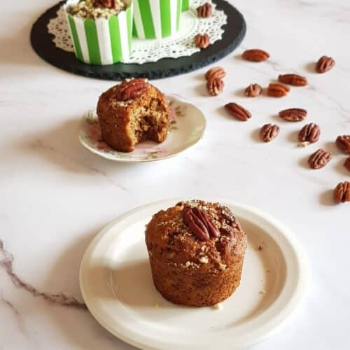 Egg-free banana muffins with pecans on a serving plate.-