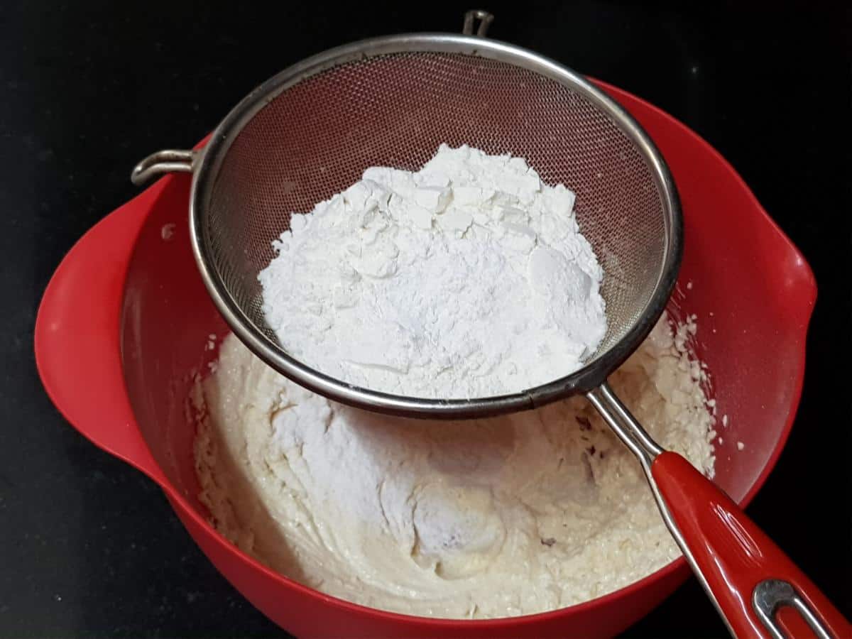 All-purpose flour, baking powder and salt mixed for coconut cranberry cookies.