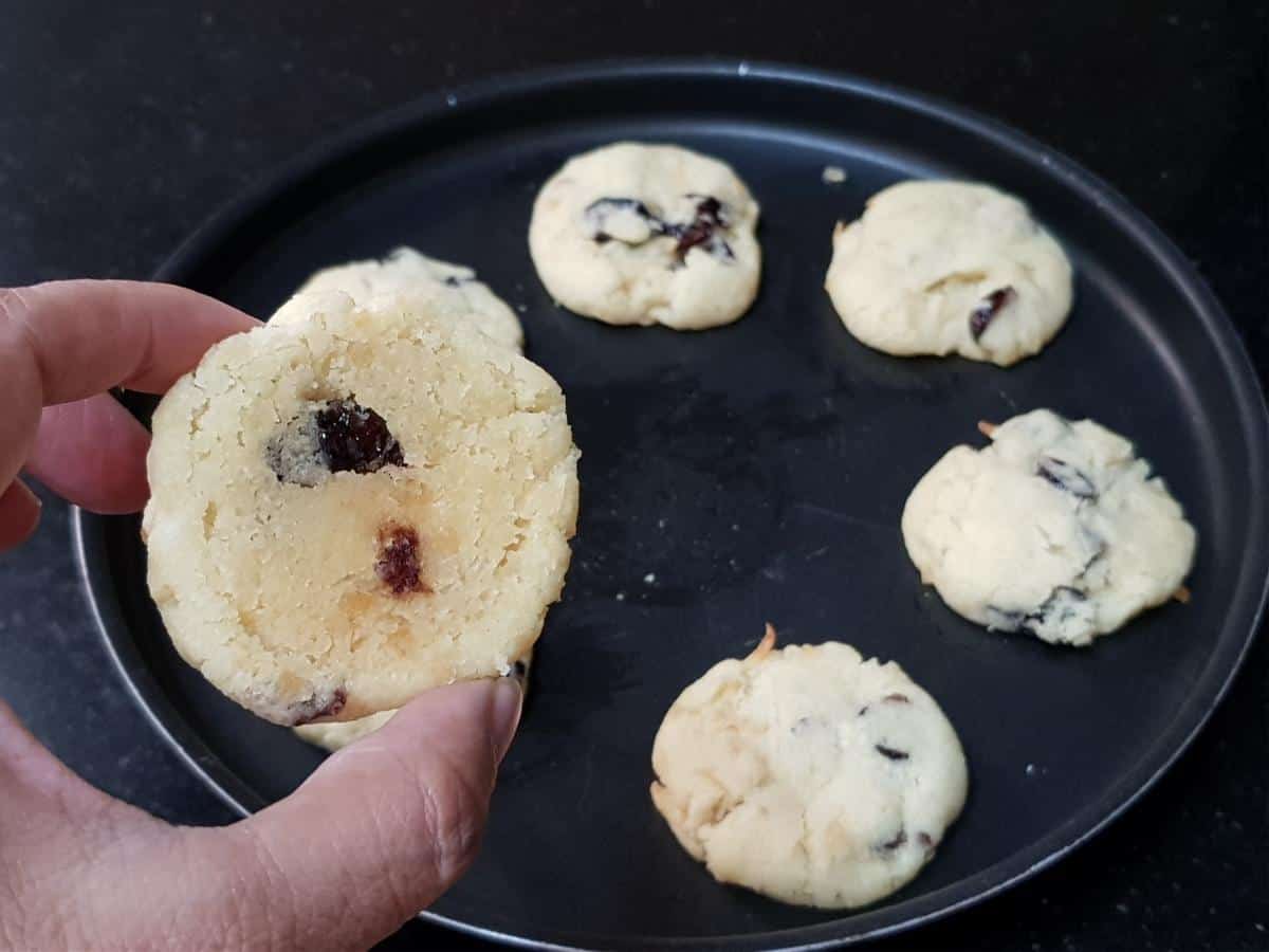 Freshly baked coconut cranberry cookies with lightly golden edges.