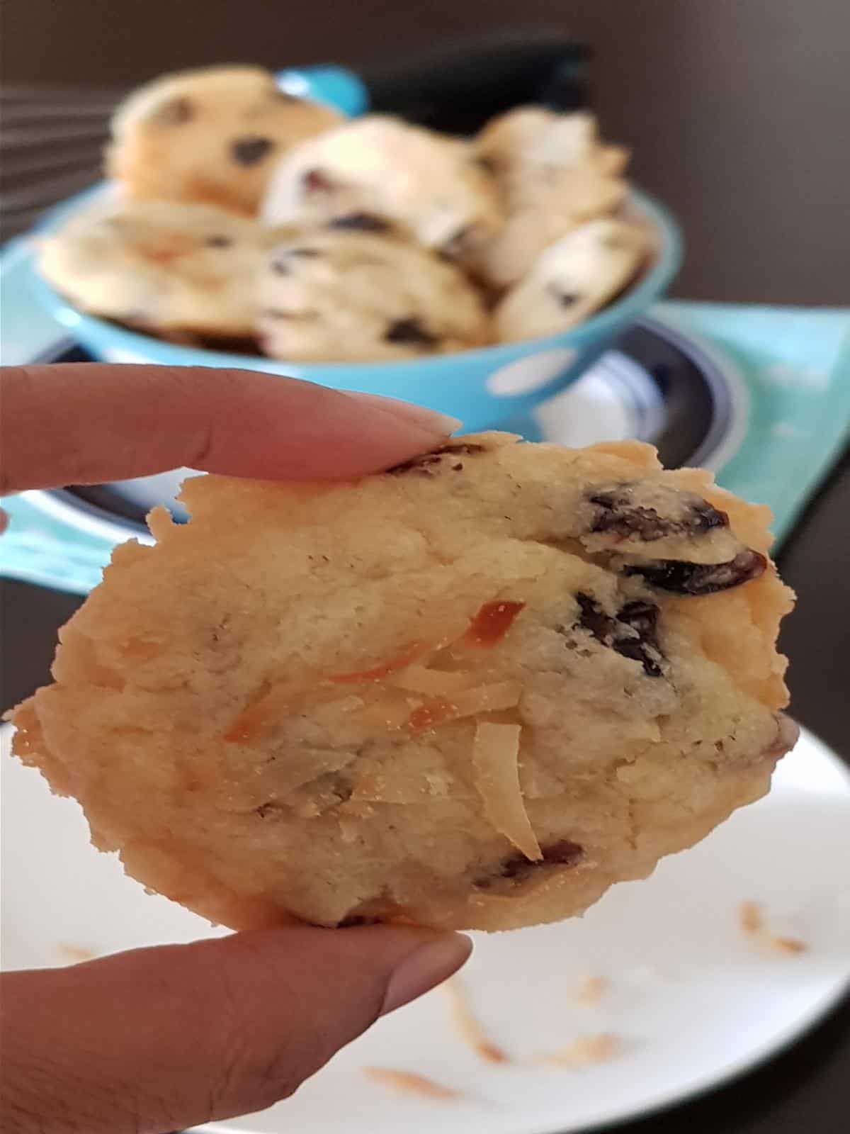 A close up of crispy edges coconut cranberry cookie.