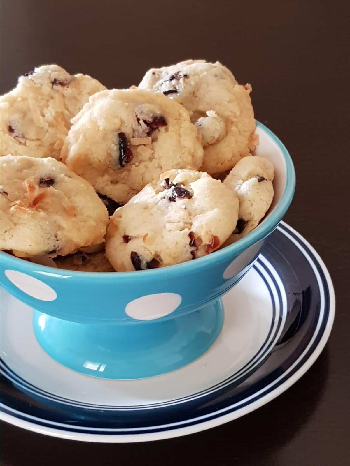 Homemade coconut cranberry cookies served in a blue bowl.