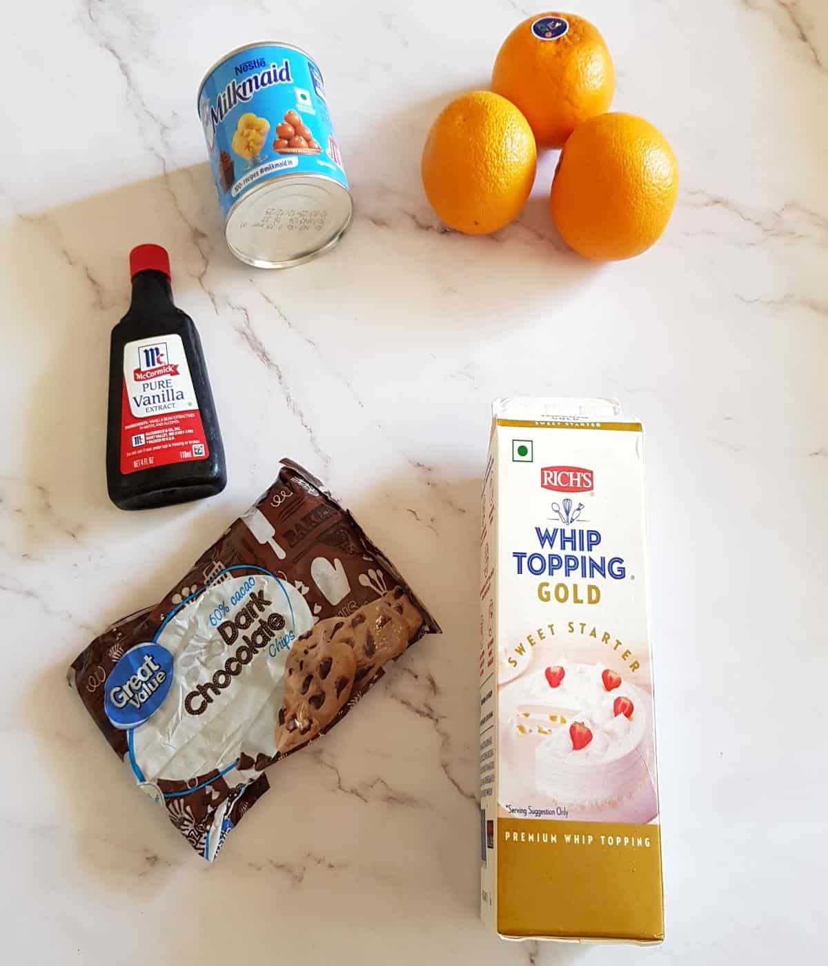 Ingredients for orange ice cream with dark chocolate chips.