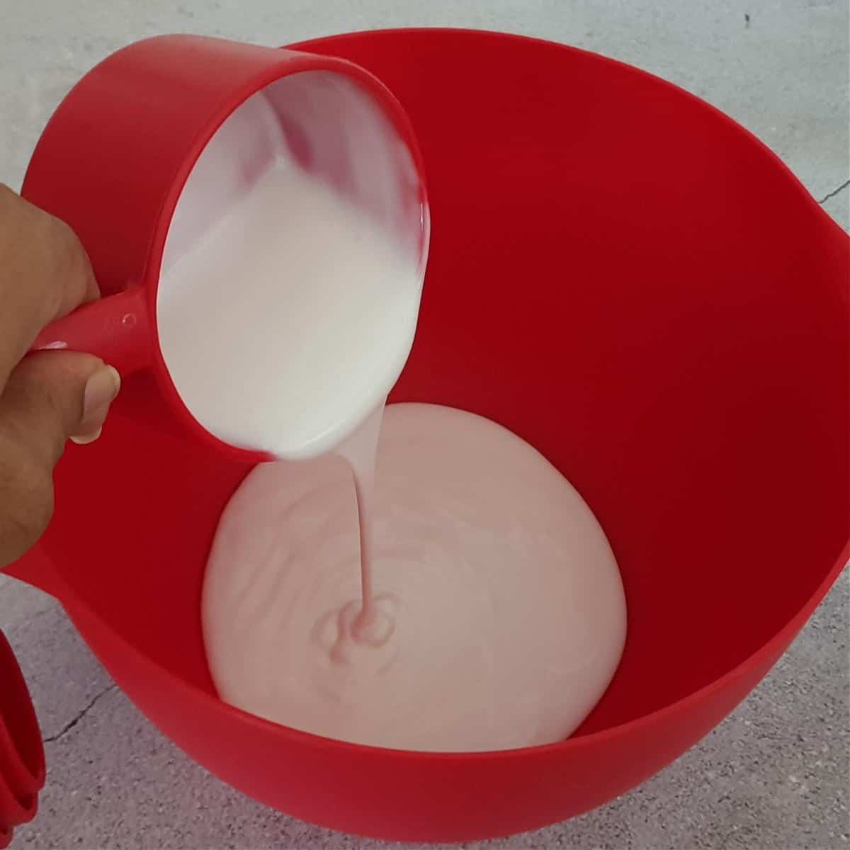 Chilled non-dairy cream whipped in a mixing bowl.