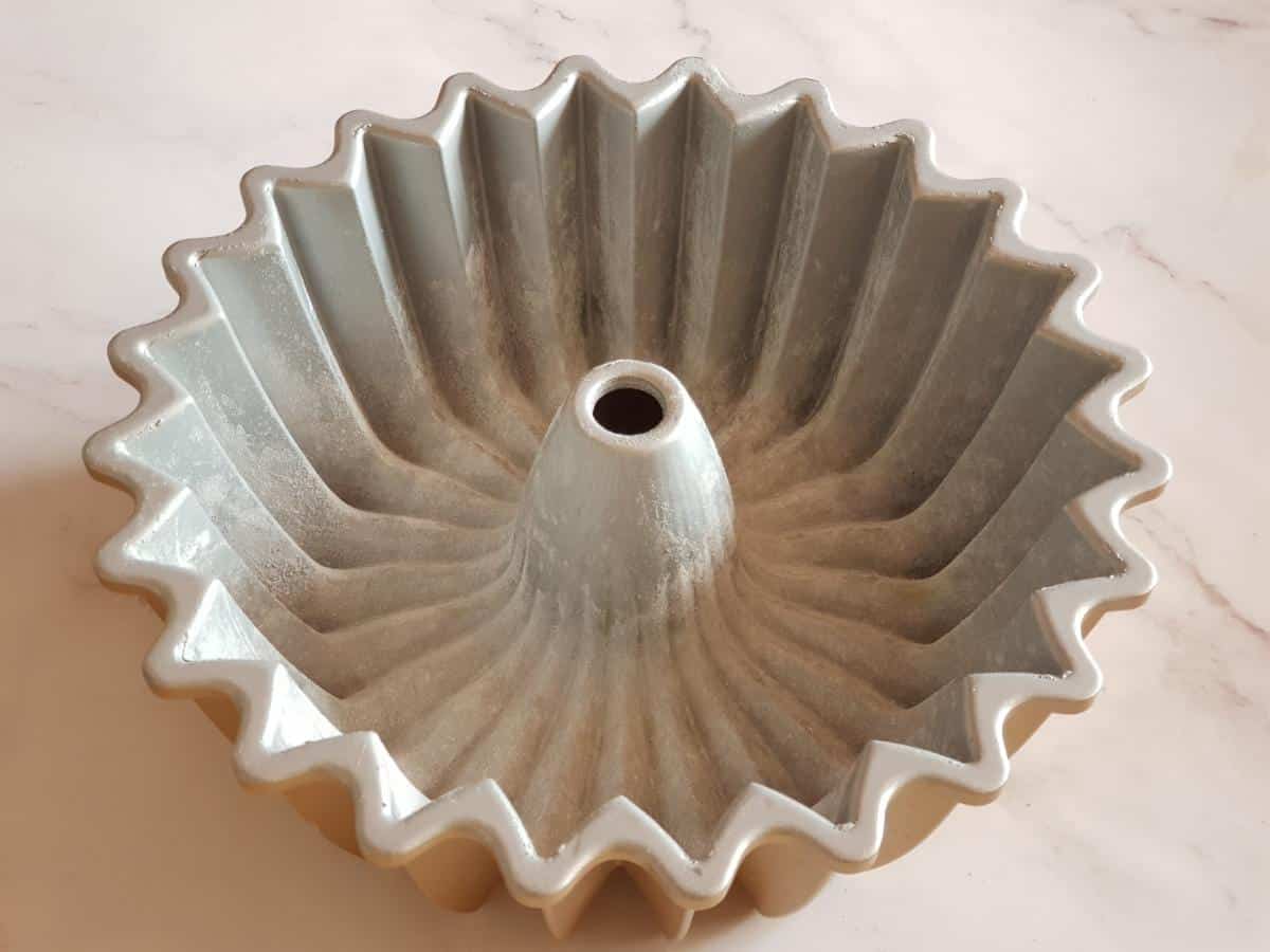 Greased 5-cup Bundt pan prepared for banana cake.