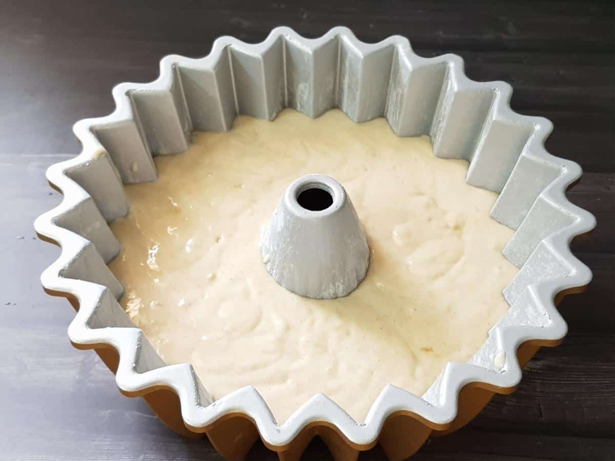 Banana cake batter poured into a prepared Bundt pan.